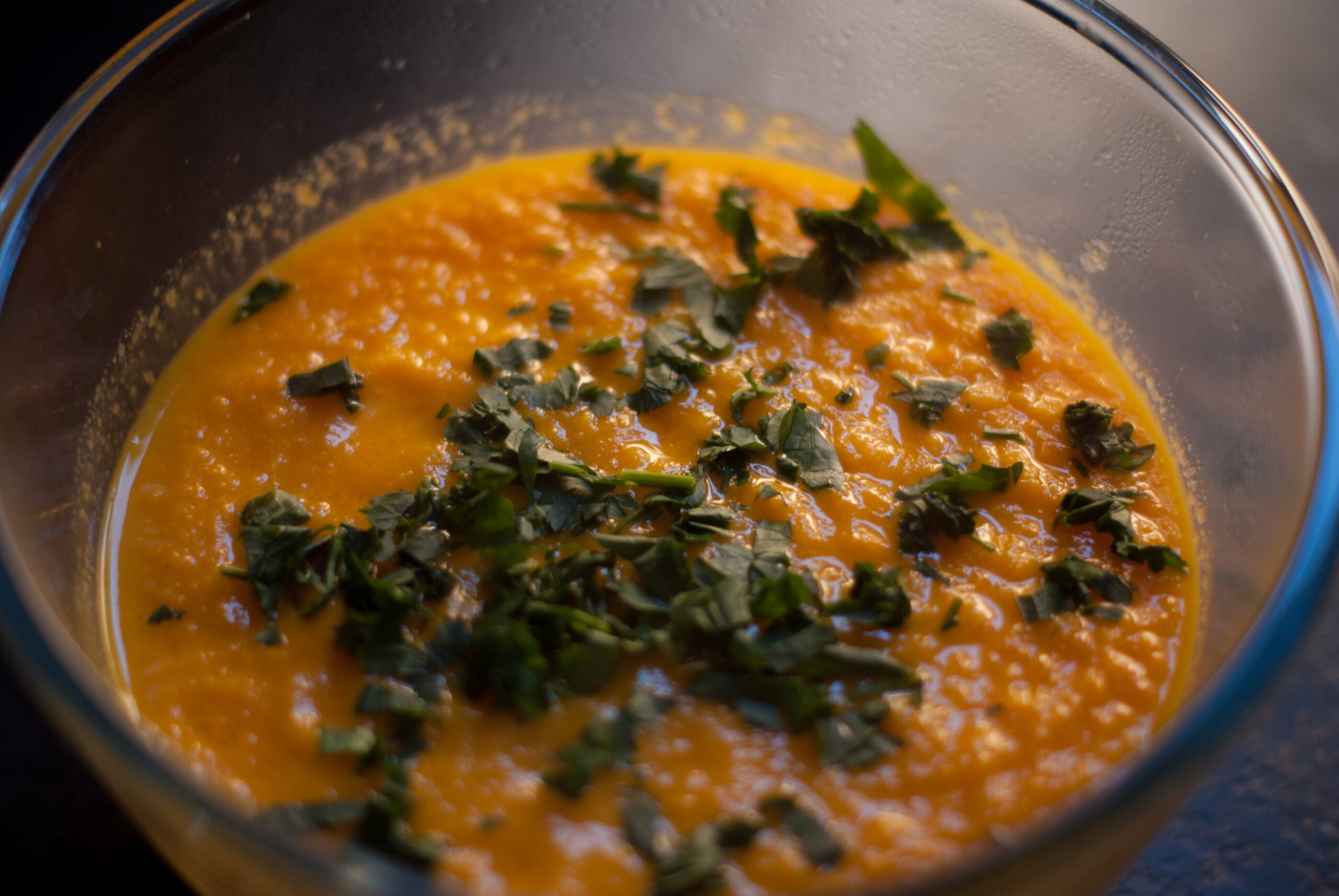 Bowl of Carrot and Ginger Soup with Parsley on top